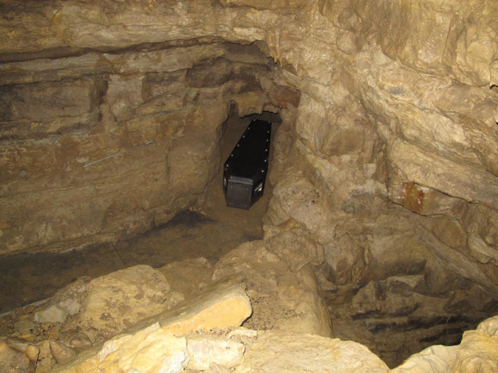 The Ackerman Burial Coffin placed in the cave system which will be its final resting place.